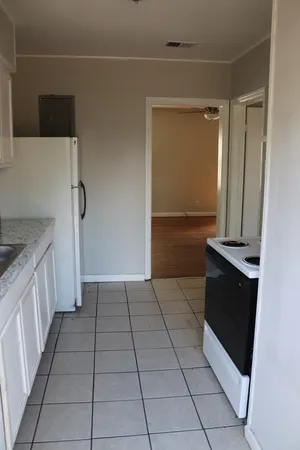 a kitchen with a sink a stove and a refrigerator