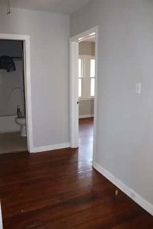 a view of a room with wooden floor and closet