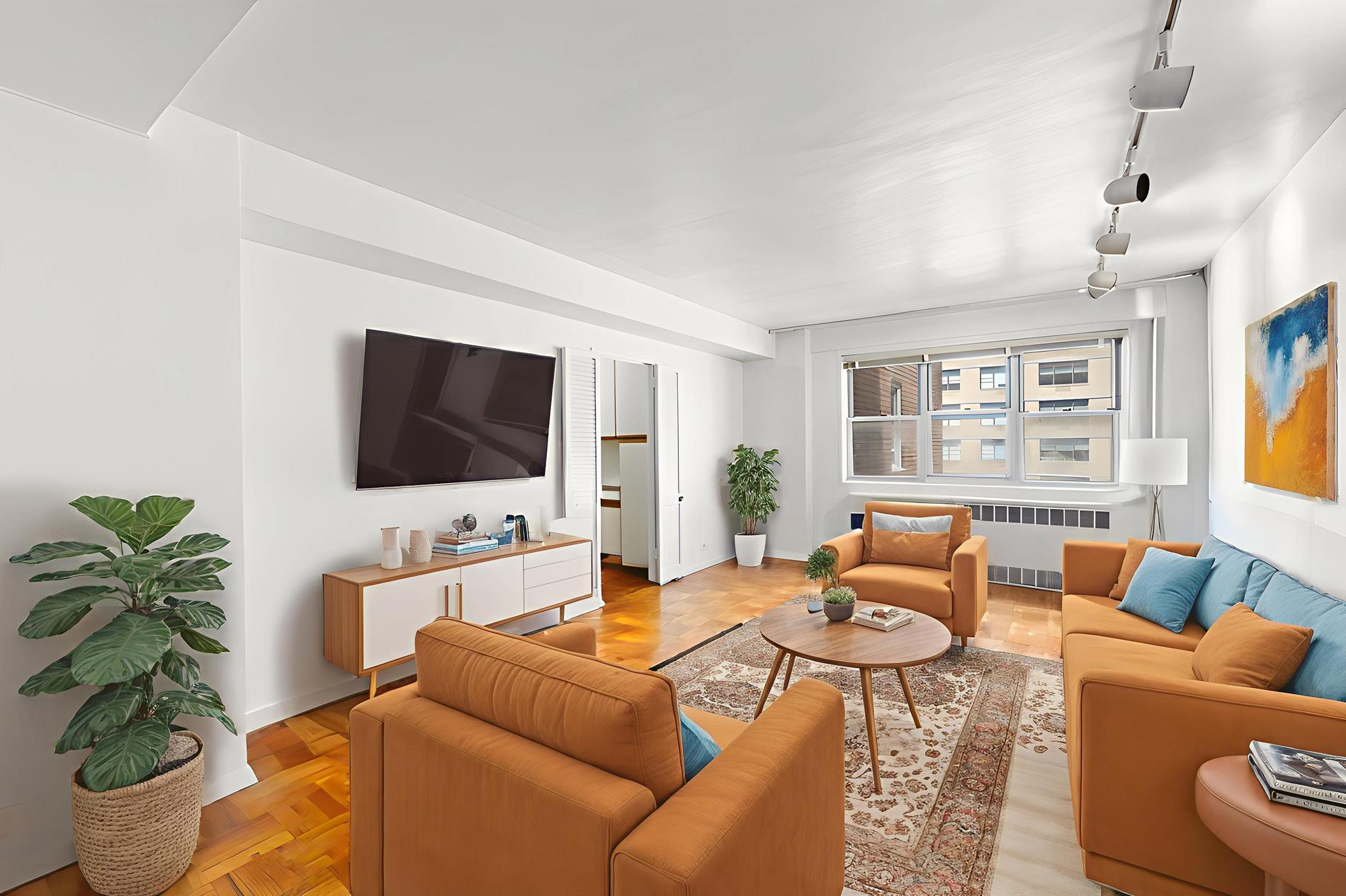 30 West 60th Street, Unit 10S Manhattan, NY 10019 - Photo 1 of 15 a living room with furniture a flat screen tv and a potted plant