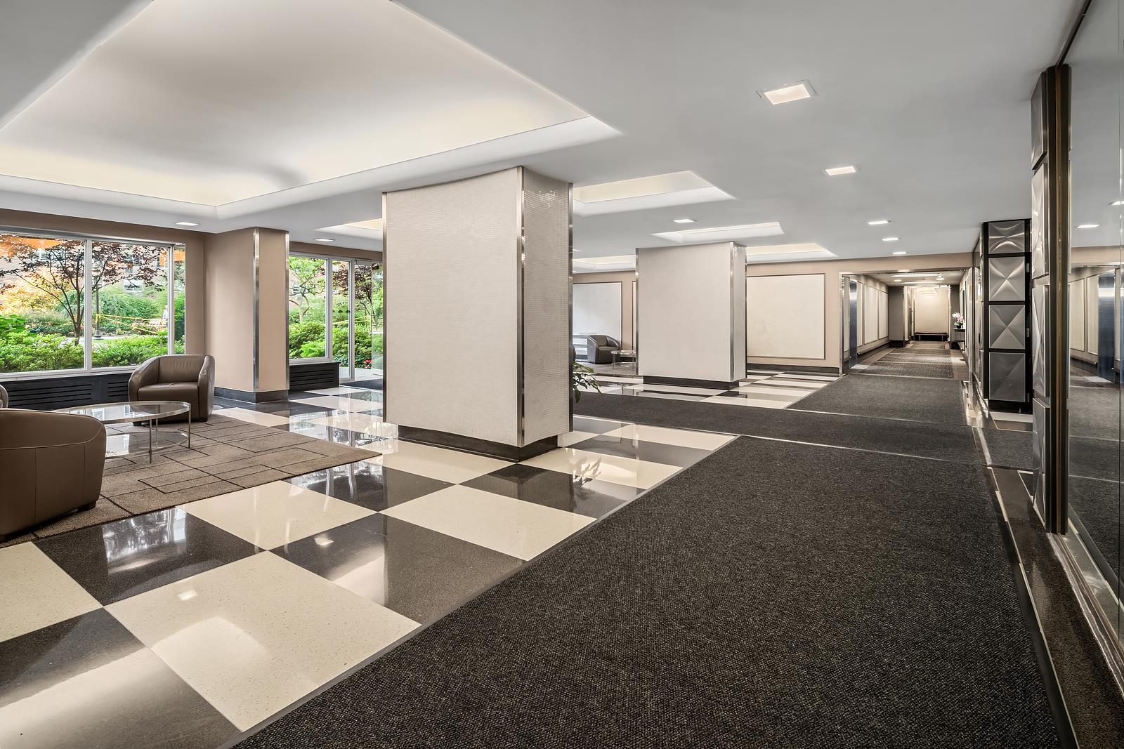 30 West 60th Street, Unit 10S Manhattan, NY 10019 - Photo 12 of 15 a lobby with furniture and floor to ceiling windows