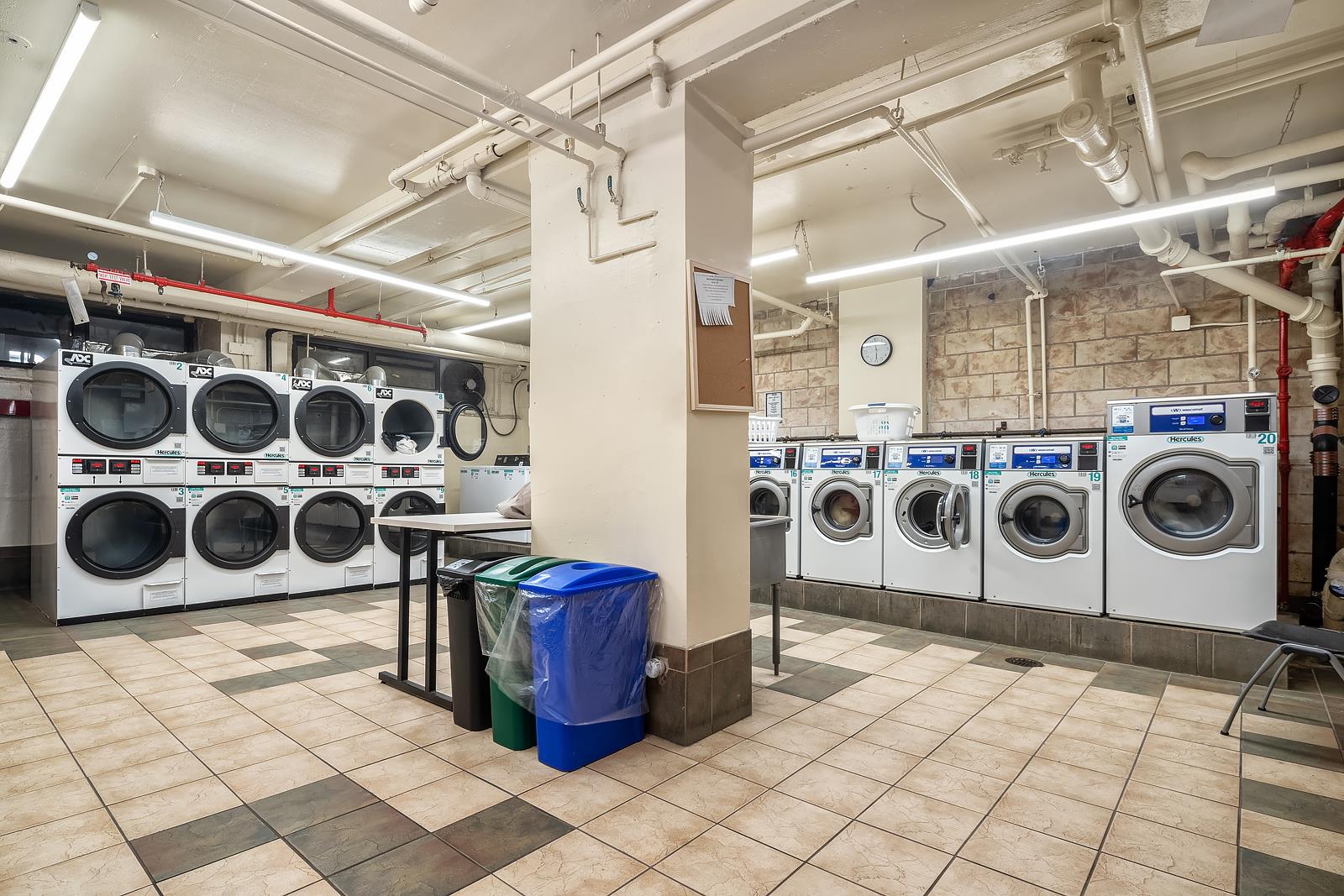 30 West 60th Street, Unit 10S Manhattan, NY 10019 - Photo 13 of 15 a utility room with stainless steel appliances and cabinets