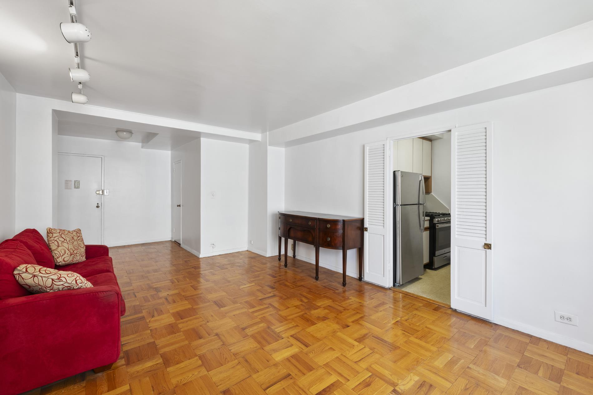 30 West 60th Street, Unit 10S Manhattan, NY 10019 - Photo 3 of 15 a bedroom with a bed and a table