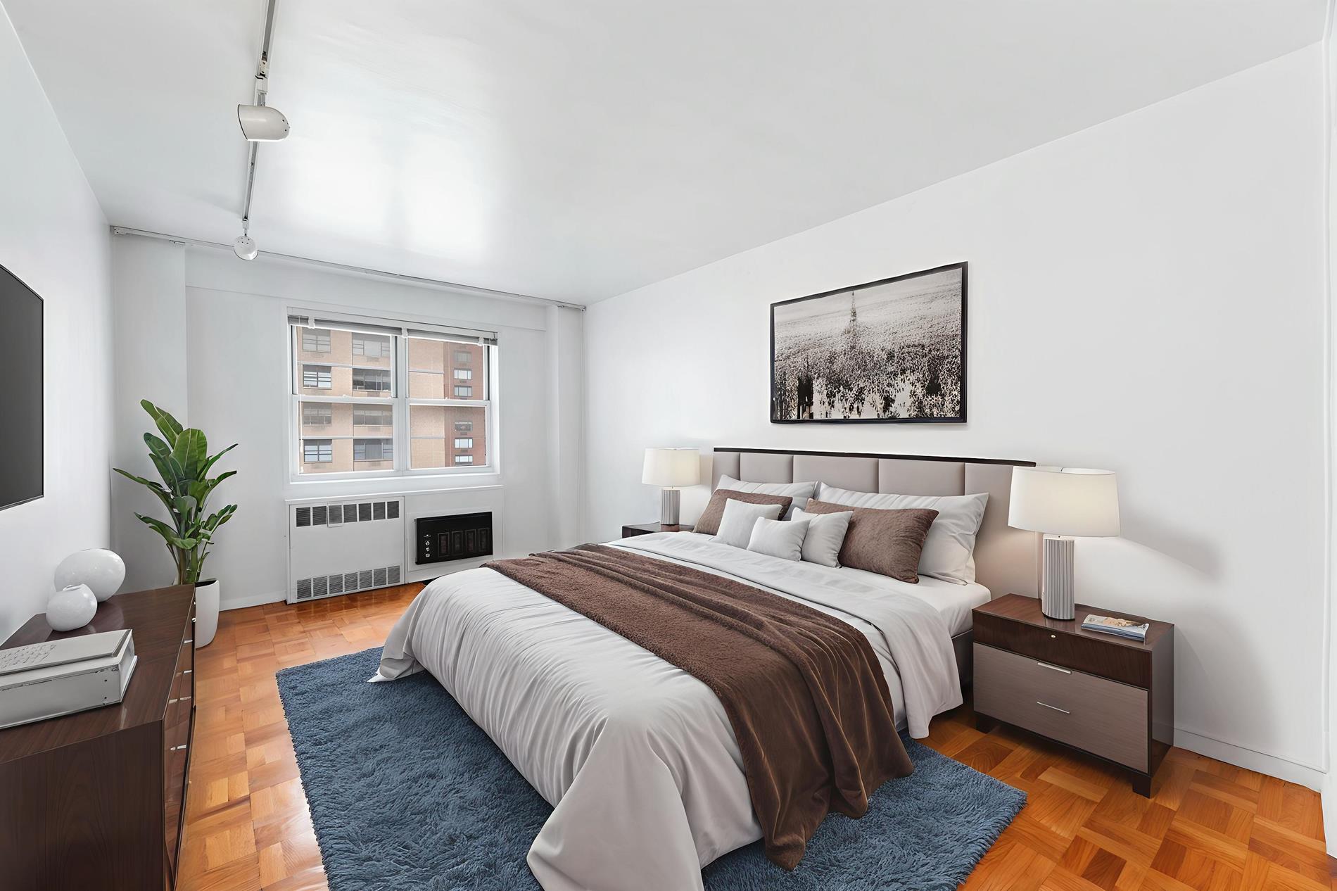 30 West 60th Street, Unit 10S Manhattan, NY 10019 - Photo 4 of 15 a bed room with a bed and a couch