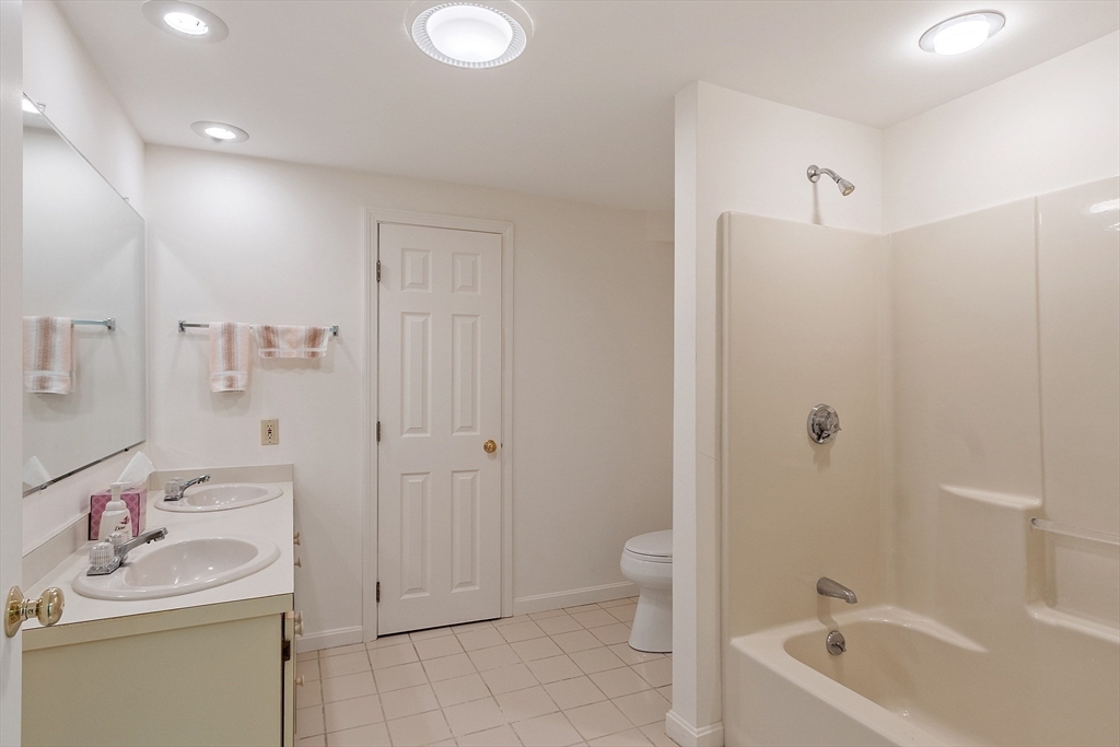 4004 Brompton Circle, Unit 4004 Worcester, MA 01609 - Photo 29 of 36 a bathroom with a granite countertop sink a toilet and shower