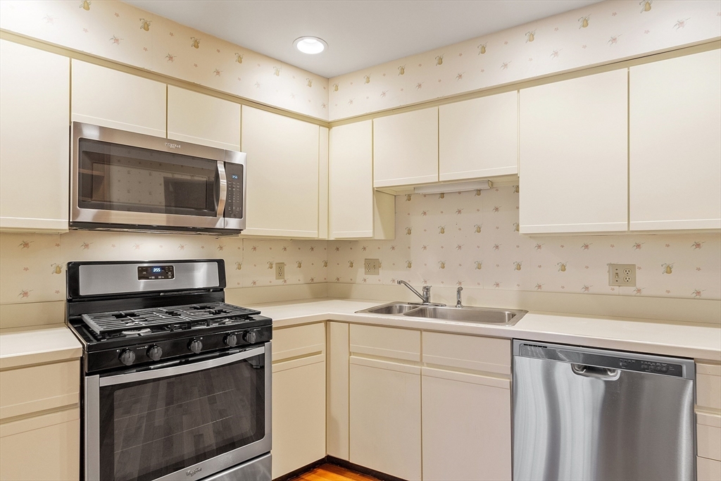 4004 Brompton Circle, Unit 4004 Worcester, MA 01609 - Photo 10 of 36 a kitchen with cabinets stainless steel appliances a sink and a counter space