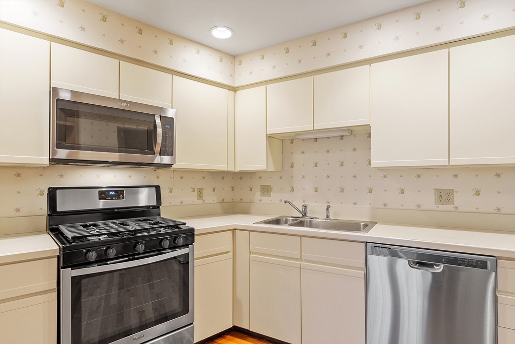 4004 Brompton Circle, Unit 4004 Worcester, MA 01609 - Photo 10 of 36 a kitchen with cabinets stainless steel appliances a sink and a counter space