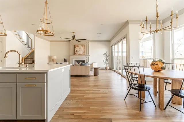 a view of a kitchen and dining room with wooden floor