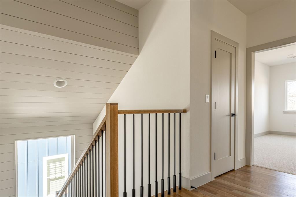 317 Travis Street Roanoke, TX 76262 - Photo 25 of 38 a view of a hallway with wooden floor and staircase