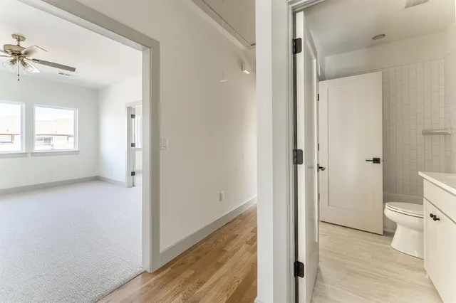 a bathroom with a bathtub shower sink vanity and toilet