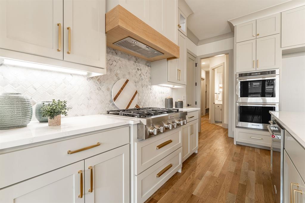 317 Travis Street Roanoke, TX 76262 - Photo 5 of 38 a kitchen with a stove and a sink
