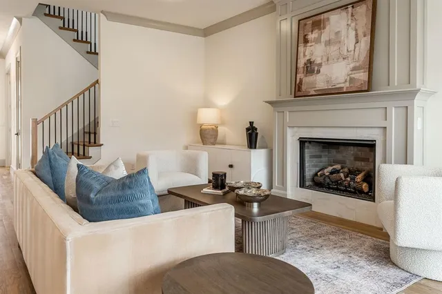 a living room with furniture a fireplace and a window