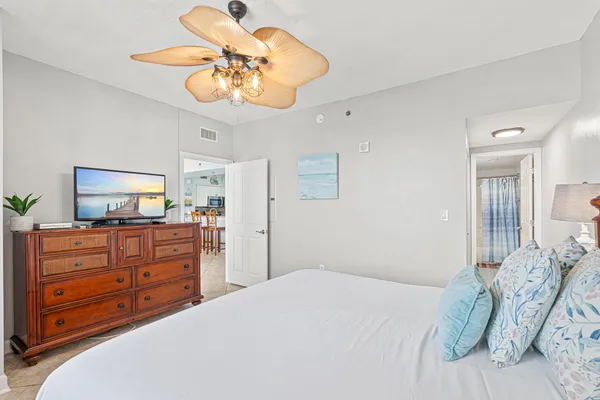 a bedroom with a bed and a chandelier