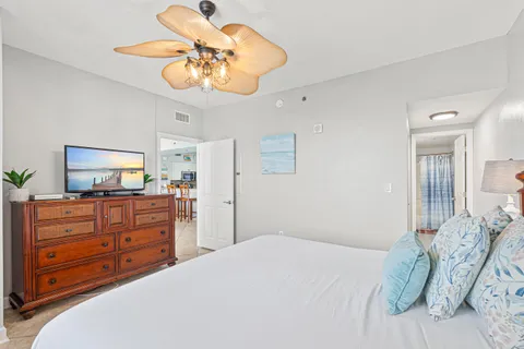 a bedroom with a bed and a chandelier