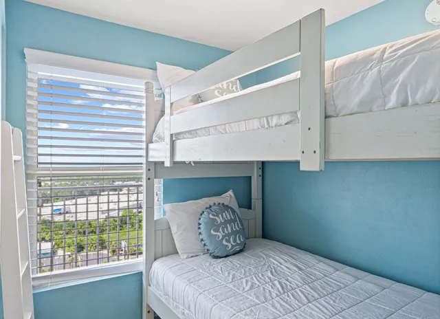 a bedroom with a bed and window