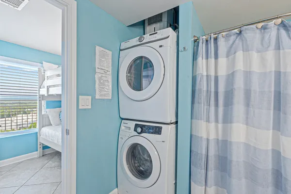 a view of a bedroom with washer and dryer