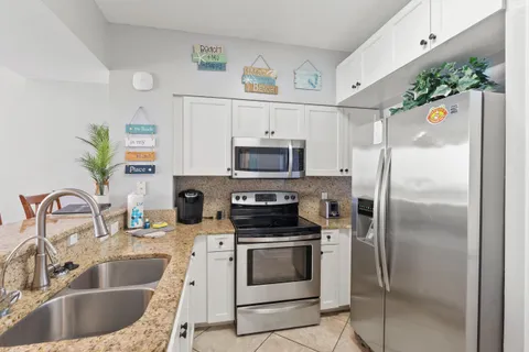 a kitchen with refrigerator and a sink