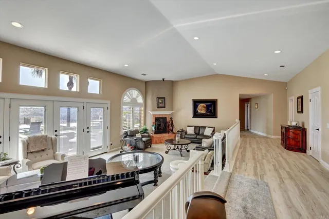 a dining room with furniture a chandelier and wooden floor