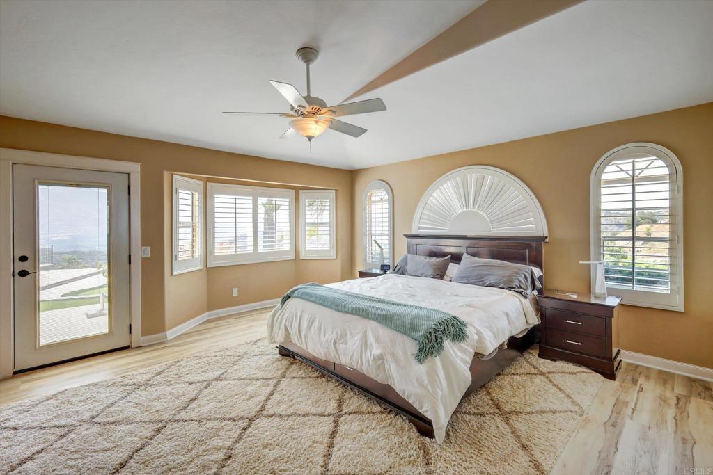36485 Carney Road Valley Center, CA 92082 - Photo 30 of 75 a bedroom with a large bed and a large window