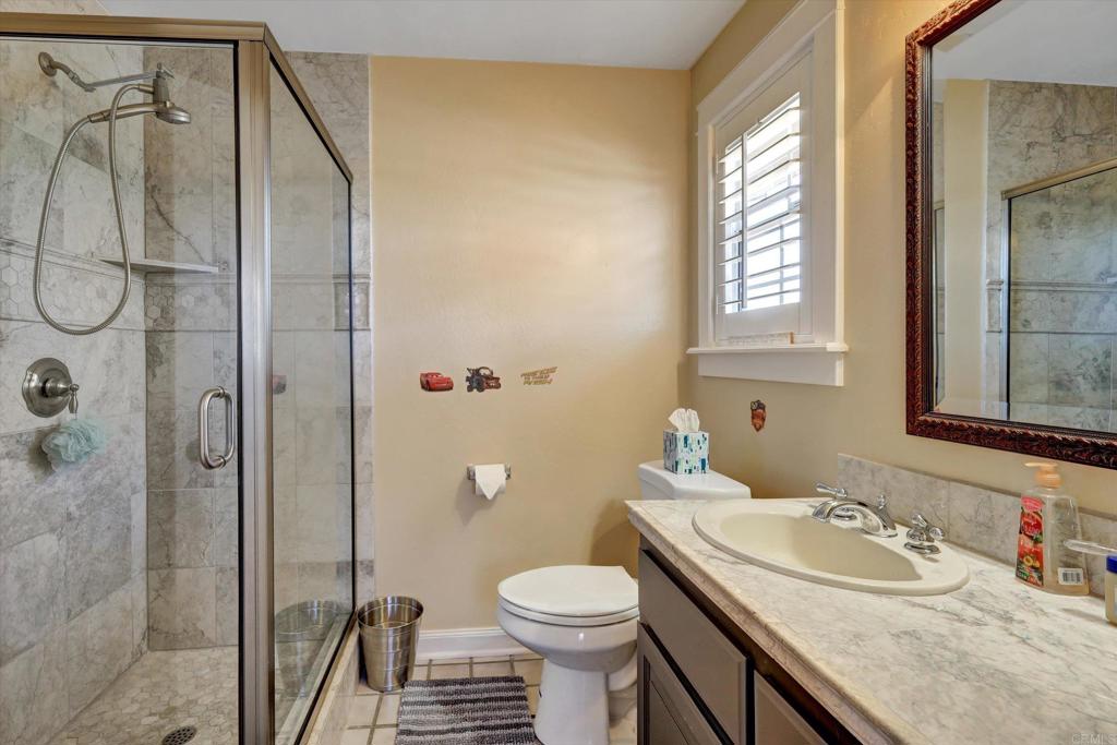 36485 Carney Road Valley Center, CA 92082 - Photo 33 of 75 a bathroom with a granite countertop sink toilet and shower