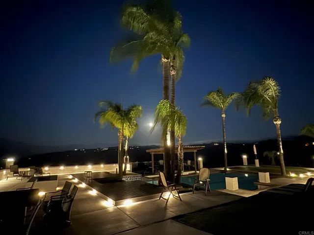 a swimming pool with outdoor seating and yard