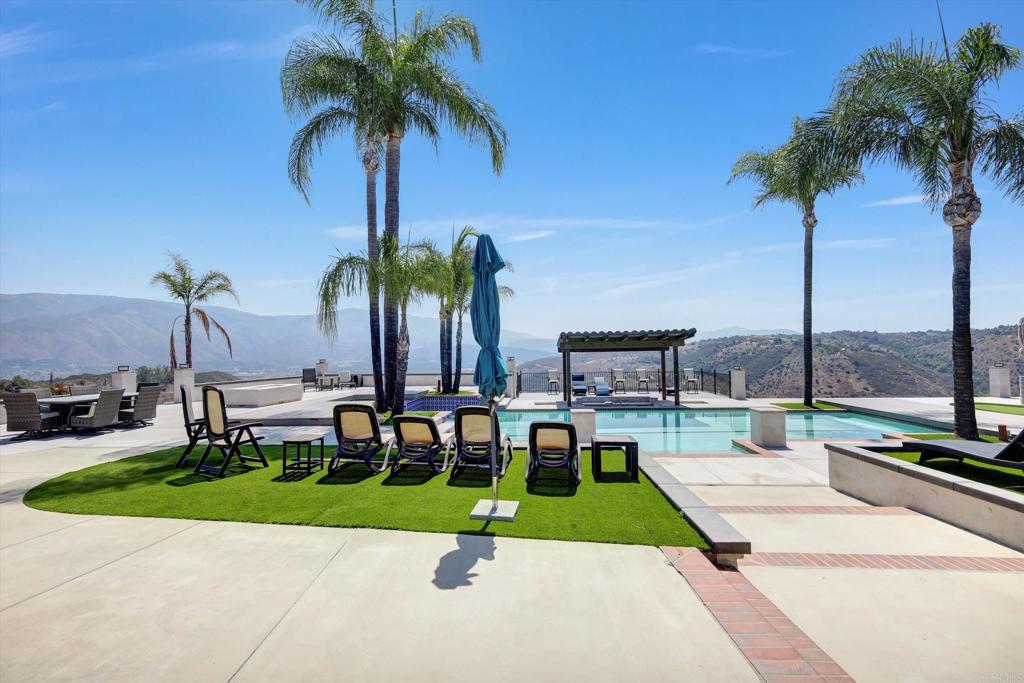 36485 Carney Road Valley Center, CA 92082 - Photo 53 of 75 a view of a swimming pool with a chair and palm trees