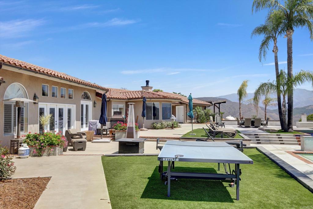 36485 Carney Road Valley Center, CA 92082 - Photo 55 of 75 a view of a patio with table and chairs potted plants and palm tree