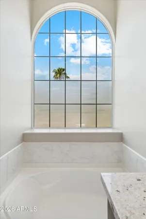 a bathroom with a bathtub and next to a window