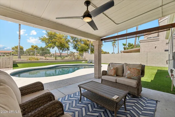 a view of a patio with couches and pool