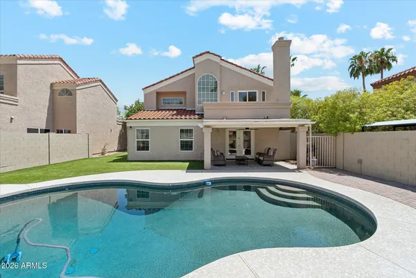a swimming pool with outdoor seating and yard
