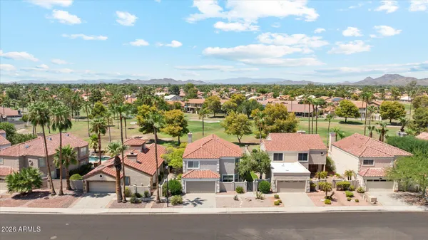 an aerial view of residential houses with city view