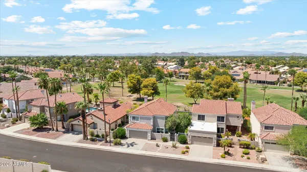 an aerial view of residential houses with outdoor space and ocean view