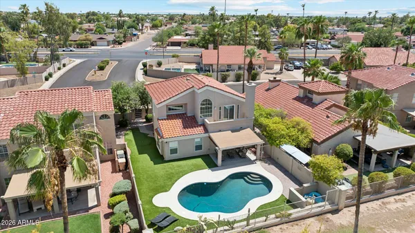 an aerial view of residential house with outdoor space and swimming pool