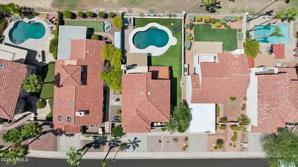 an aerial view of residential houses with outdoor space and parking