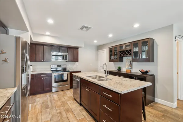 a kitchen with a sink stove and refrigerator