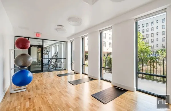 a bedroom with a large bed and a large sliding window