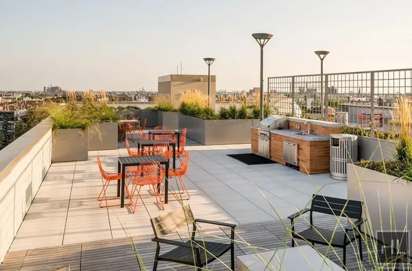 a view of a terrace with furniture and stove