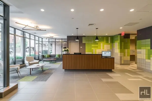 a living room with kitchen island furniture and a flat screen tv