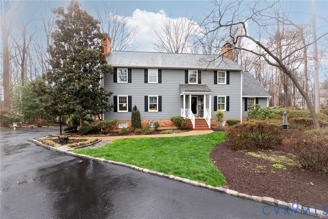 11920 Rothbury Drive Richmond, VA 23236 - Photo 1 of 68 a front view of a house with a garden and trees