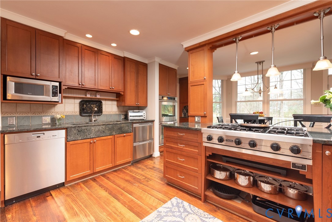11920 Rothbury Drive Richmond, VA 23236 - Photo 11 of 68 a kitchen with stainless steel appliances a stove a sink and a microwave