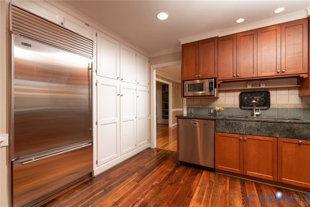11920 Rothbury Drive Richmond, VA 23236 - Photo 12 of 68 a kitchen with kitchen island granite countertop wooden cabinets and stainless steel appliances