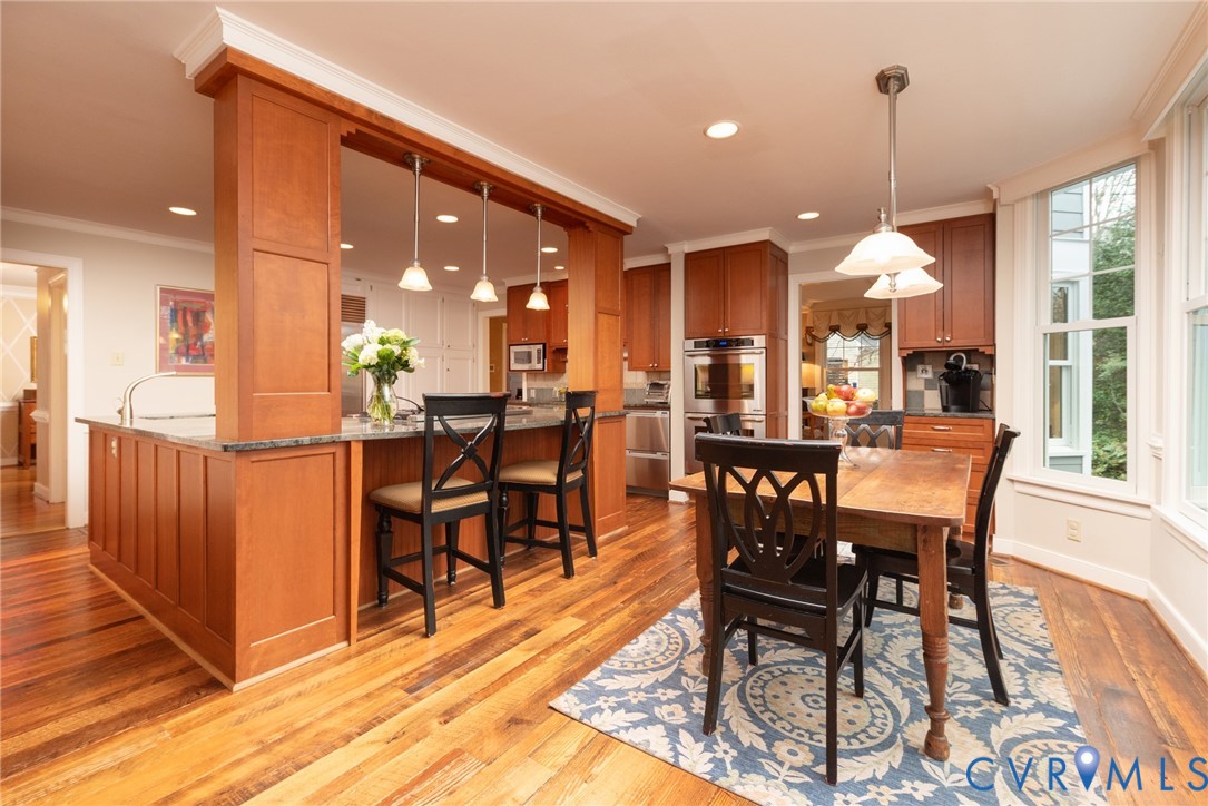 11920 Rothbury Drive Richmond, VA 23236 - Photo 13 of 68 a dining hall view with a dining table chairs and white cabinets