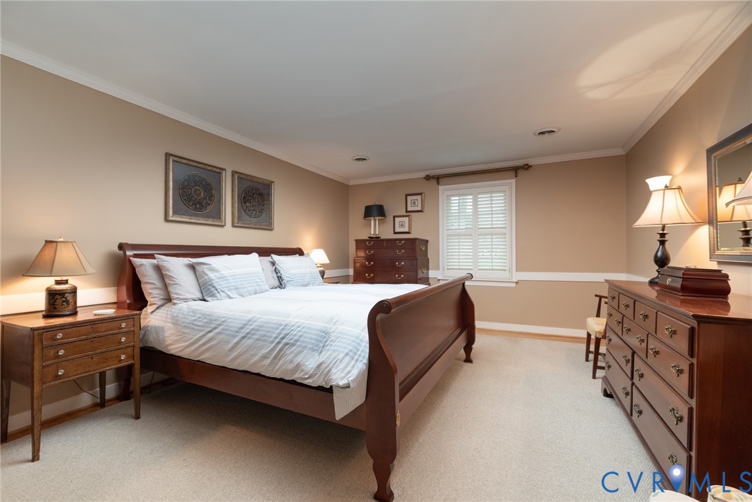 11920 Rothbury Drive Richmond, VA 23236 - Photo 21 of 68 a bedroom with a bed and a dresser next to a window