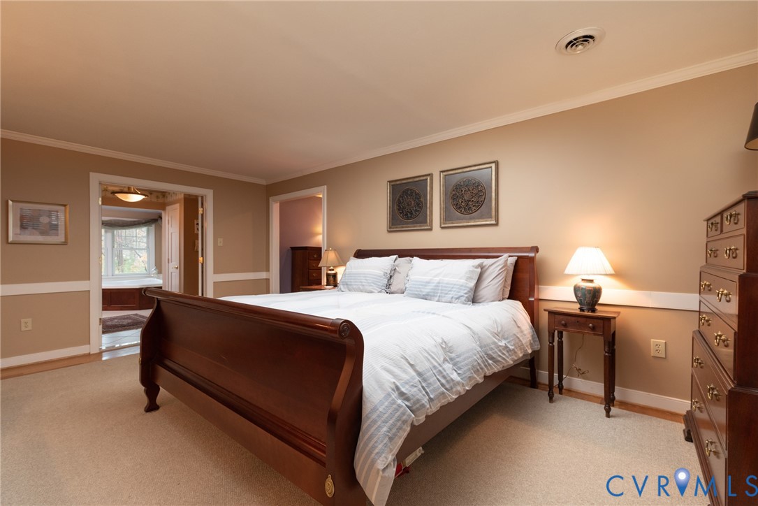 11920 Rothbury Drive Richmond, VA 23236 - Photo 22 of 68 a spacious bedroom with a bed and a table