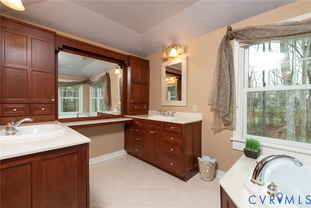 11920 Rothbury Drive Richmond, VA 23236 - Photo 24 of 68 a spacious bathroom with a granite countertop sink mirror and a bathtub