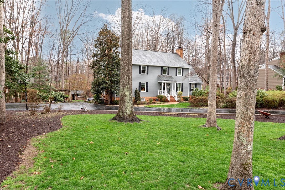 11920 Rothbury Drive Richmond, VA 23236 - Photo 3 of 68 a front view of a building with a garden and trees
