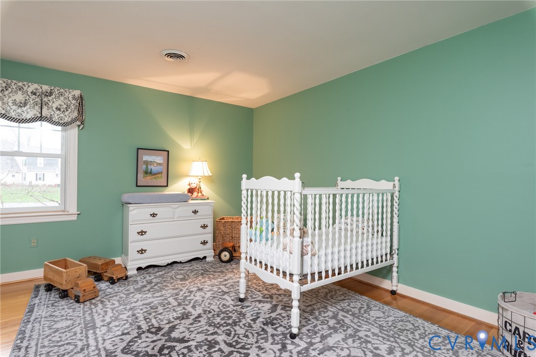11920 Rothbury Drive Richmond, VA 23236 - Photo 31 of 68 a room with a baby crib and a window