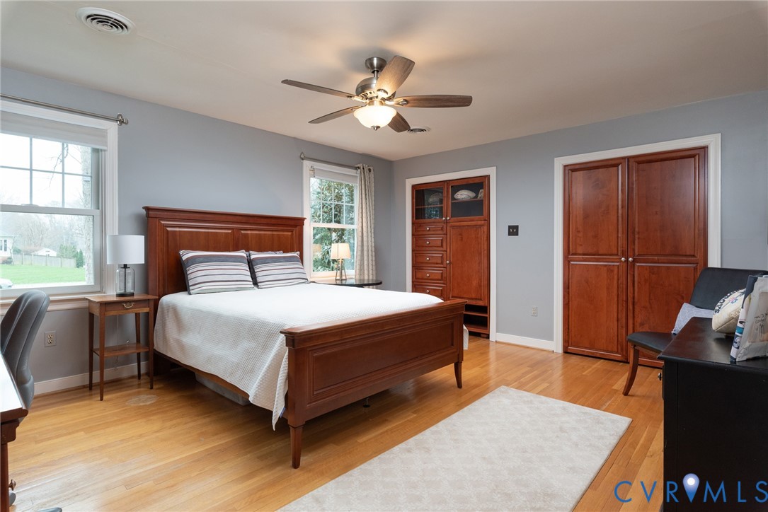 11920 Rothbury Drive Richmond, VA 23236 - Photo 32 of 68 a bedroom with a bed and wooden floor