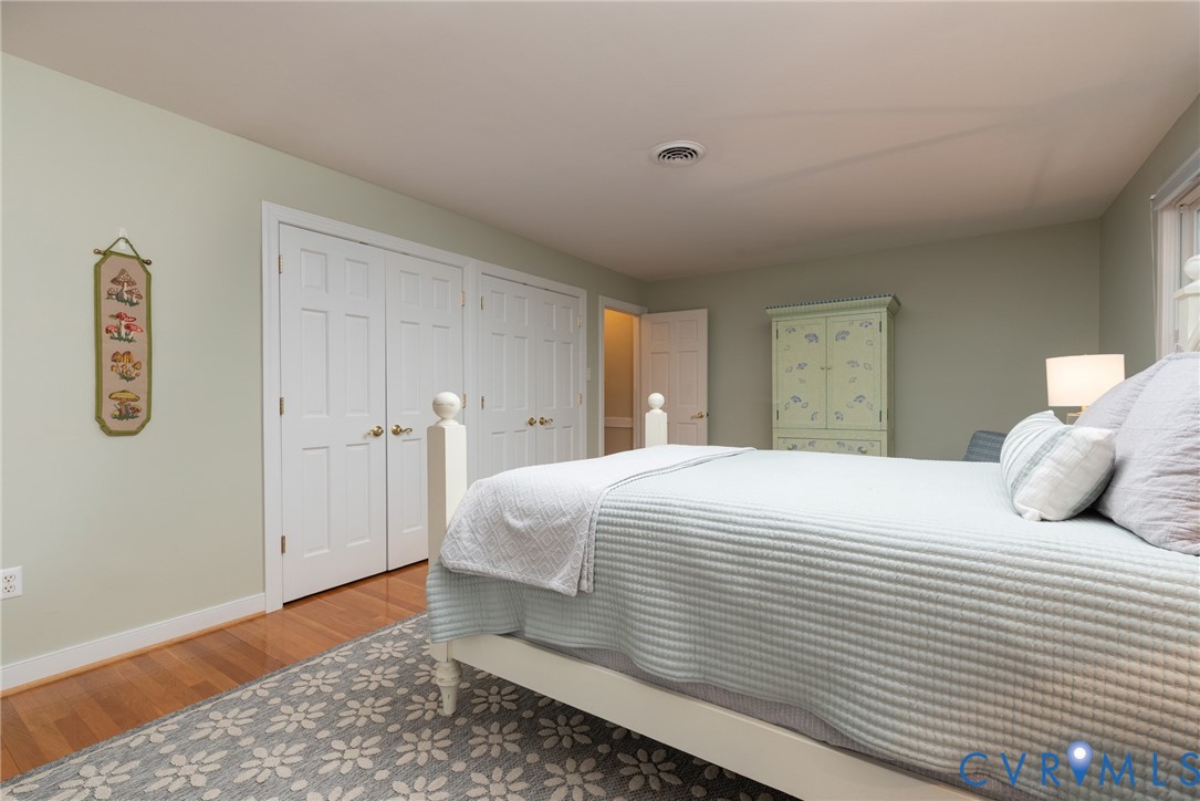 11920 Rothbury Drive Richmond, VA 23236 - Photo 35 of 68 a bedroom with a bed and wooden floor