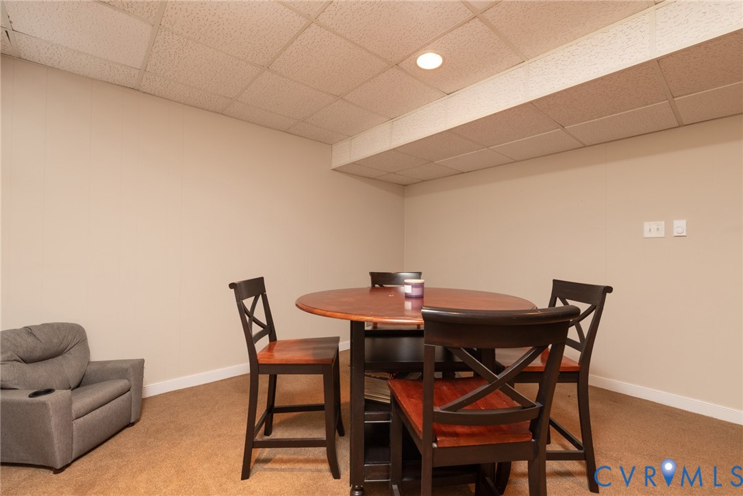 11920 Rothbury Drive Richmond, VA 23236 - Photo 42 of 68 a view of a dining room with furniture and a potted plant