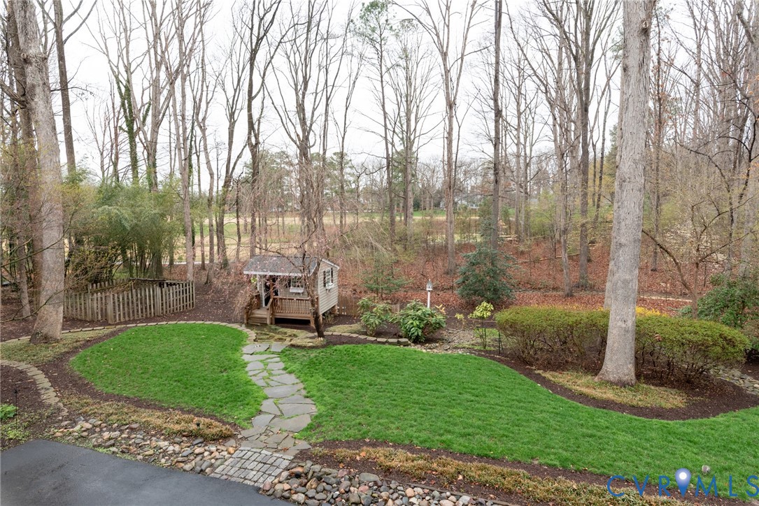 11920 Rothbury Drive Richmond, VA 23236 - Photo 49 of 68 a garden with trees in front of it